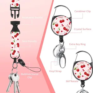 Cherry print lanyard with retractable badge reel, breakaway buckle, and multiple key clips.