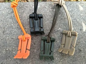 Outdoor multi-functional backpack buckle detail view, showing four color variants with elastic cords.