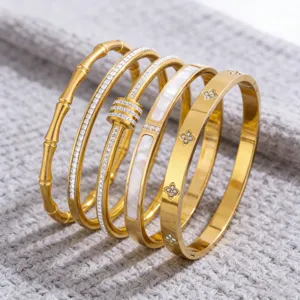 Set of 5 stainless steel 18k gold plated fashion bangles with crystals and mother of pearl.