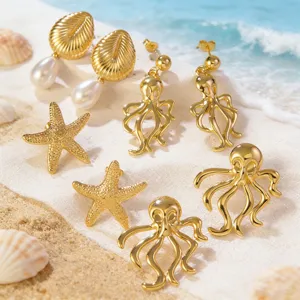 Detailed closeup view of gold ocean series earrings featuring starfish, conch and octopus.