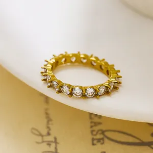 Detailed close-up shot of luxurious gold plated eternity ring featuring brilliant prong set zirconia.