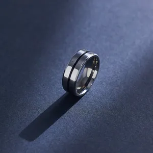 Close-up detail shot of the minimalist titanium steel ring featuring a sleek central groove design.