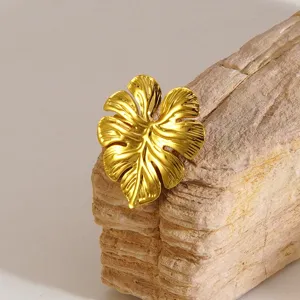 Close-up detail shot of the elegant gold leaf brooch, showcasing exquisite textured leaf design.