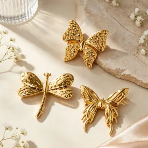 Gold butterfly and dragonfly brooch details, exquisite metal texture, elegant fashion accessory.