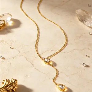 Close-up of elegant gold Y-shaped drop necklace with sparkling crystal pendants for chic daily wear.