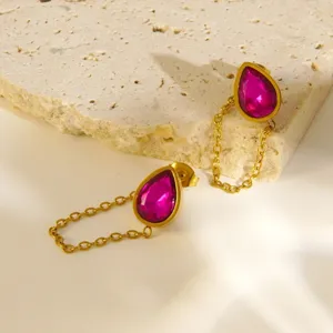 Gold stainless steel teardrop pink crystal chain earrings detail shot, elegant jewelry.