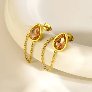 Close-up detail of 18k gold plated stainless steel teardrop crystal chain earrings luxury.