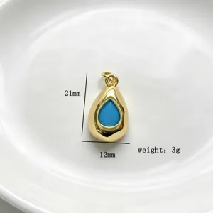 Detailed view of the gold teardrop pendant with blue center, showing size dimensions clearly.