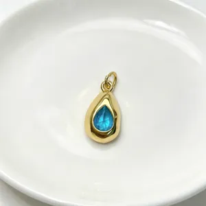 Exquisite teardrop blue crystal pendant with gold-tone frame, delicate detail for necklace.