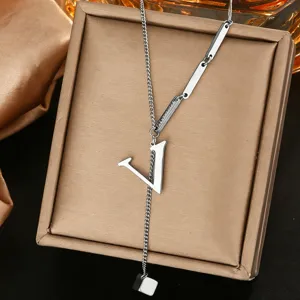 Detail shot of a silver letter V pendant necklace on a jewelry box, exquisite and delicate.