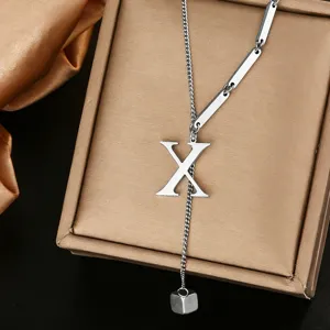 Close-up of stainless steel letter X pendant Y necklace, stylish titanium steel jewelry.