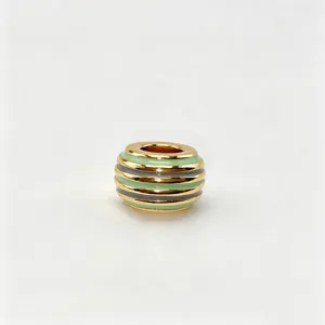 Detailed view of gold plated metal charm bead with green and grey enamel striped design.