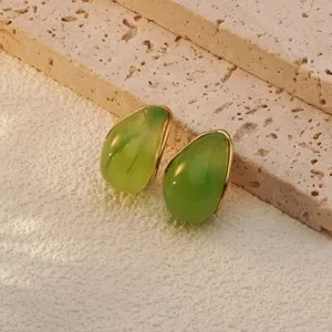 Elegant green teardrop stud earrings with gold trim, stylish stainless steel jewelry.