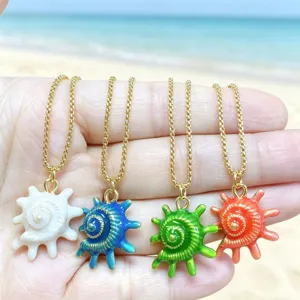 Close-up of four colorful enameled conch shell pendants on gold chains, ocean jewelry detail.
