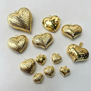 Detailed view of various gold-plated heart charms with diverse textures for DIY jewelry.