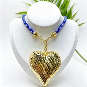 Golden textured 3D heart pendant necklace with blue braided cord fashion accessory