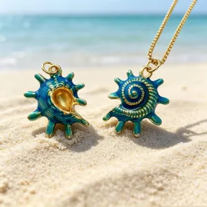 Ocean style blue green enamel conch pendant detail, exquisite gold trim and beach backdrop.