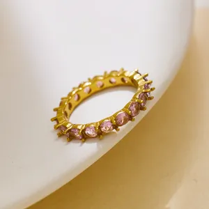Close-up view of 18K gold plated stainless steel eternity ring featuring pink cubic zirconia stones.