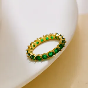 Detail view of the 18K gold-plated full circle green zircon eternity ring closeup shot.