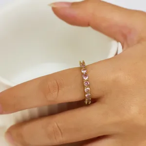 Detailed close-up of a stunning 18K gold plated full pink zircon ring worn elegantly on finger.