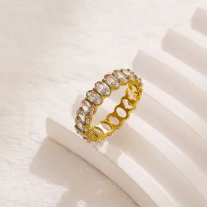 Exquisite detail shot of a full-eternity oval zirconia gold ring, showcasing prong-set brilliance.