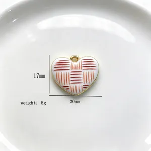 Detailed view of a red and white enamel heart pendant showcasing its intricate line pattern.