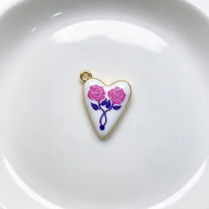 Detailed view of enamel rose heart pendant necklace charm, exquisite gold edge retro jewelry.