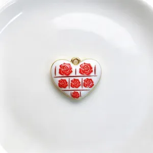 Close up view of red rose heart pendant detail, elegant golden rim enamel jewelry component.