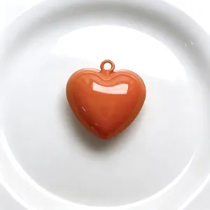 Orange baked paint heart pendant charm for DIY handmade jewelry and necklace accessories.