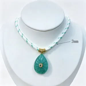 Detailed close-up of the green teardrop crystal pendant necklace featuring a 3mm cord.