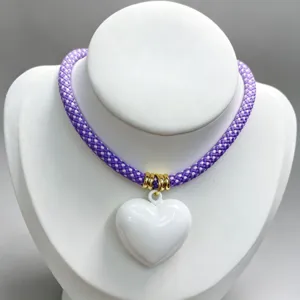 Purple braided rope necklace with white heart pendant fashion DIY jewelry detail view shot