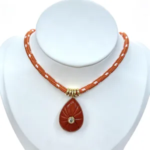 Detail view of the teardrop natural stone pendant necklace with sparkling zirconia.