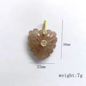 Heart carved crystal gemstone pendant with gold bail and inlaid zircon for DIY jewelry making.