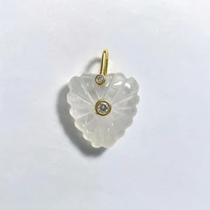 Natural carved crystal heart pendant with gold-plated bezel setting and sparkling cubic zirconia stones.