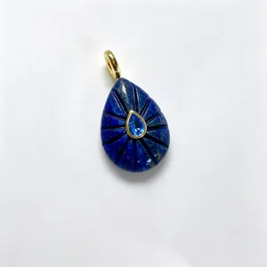 Natural stone teardrop carved pendant with center blue gemstone and gold-tone bail accessory.