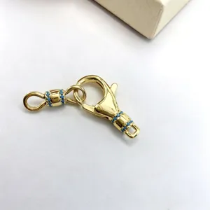 Close up of gold plated DIY jewelry spring clasp connector with blue micro inlay stones detail