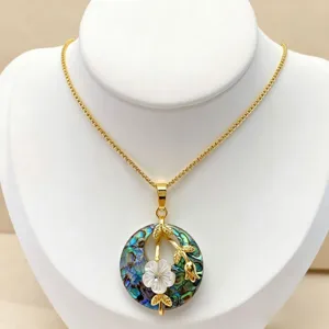 Close-up detail of ethnic style round abalone shell pendant necklace with mother-of-pearl flower.