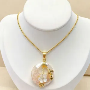 Exquisite natural abalone shell pendant necklace featuring intricate gold floral design detail.