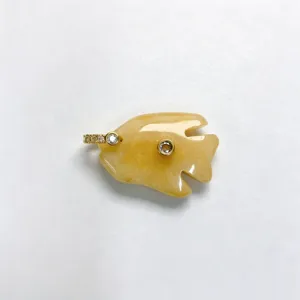 Close-up detail of a carved yellow stone tropical fish pendant with sparkling zircon insets.
