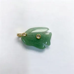 Close-up of carved green jade fish pendant with sparkling zircon inlay and gold hardware detail.