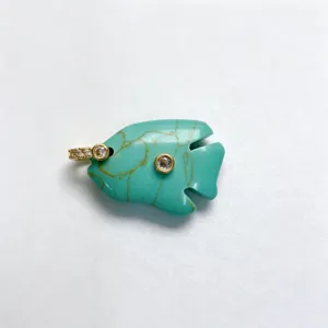 Detailed close-up of a carved turquoise fish pendant featuring sparkling zircon insets.