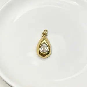 Exquisite gold teardrop pendant featuring a sparkling clear crystal gemstone for chic style.