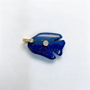 Natural lapis lazuli fish pendant detail view, gemstone animal necklace accessory.