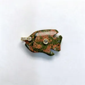 Natural unakite stone tropical fish pendant with set zirconia details, elegant carved jewelry.