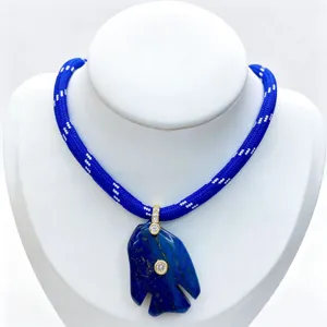 Blue lapis lazuli fish pendant necklace with braided blue rope and diamond gold accents.