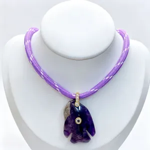 Exquisite amethyst carved fish pendant necklace with purple braided cord and sparkling cubic zirconia.