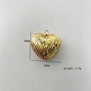 Close-up detail of the 30mm double-sided gold plated heart pendant jewelry accessory.