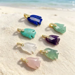 Natural stone crystal carved fish pendant, ocean style jewelry accessory detail.