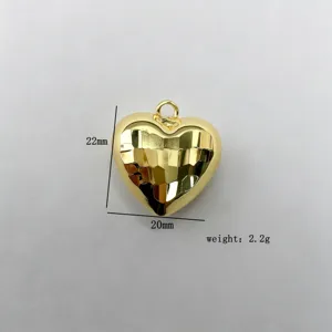 Gold faceted puffy heart pendant detail view, copper plated DIY jewelry accessory.