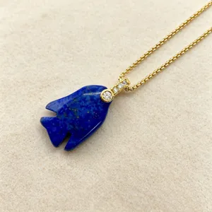 Natural lapis lazuli fish pendant necklace with gold chain and sparkling crystal details.